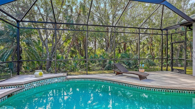 view of pool with a lanai and a patio