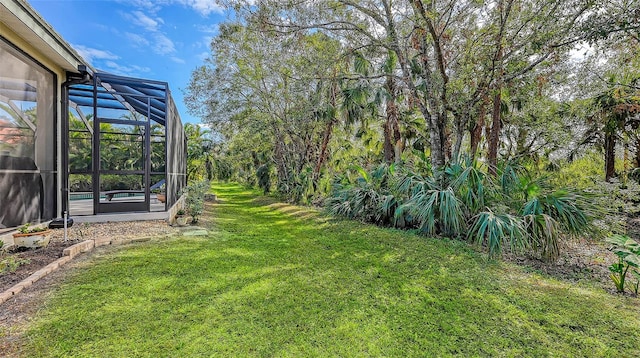 view of yard with glass enclosure