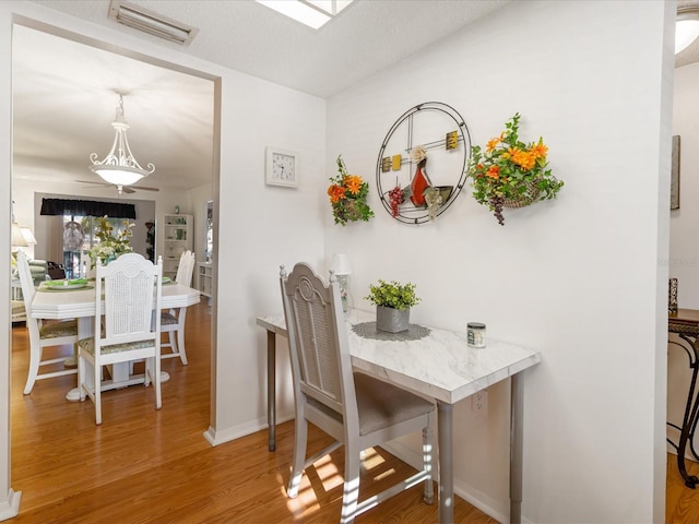 dining room featuring hardwood / wood-style floors and a textured ceiling