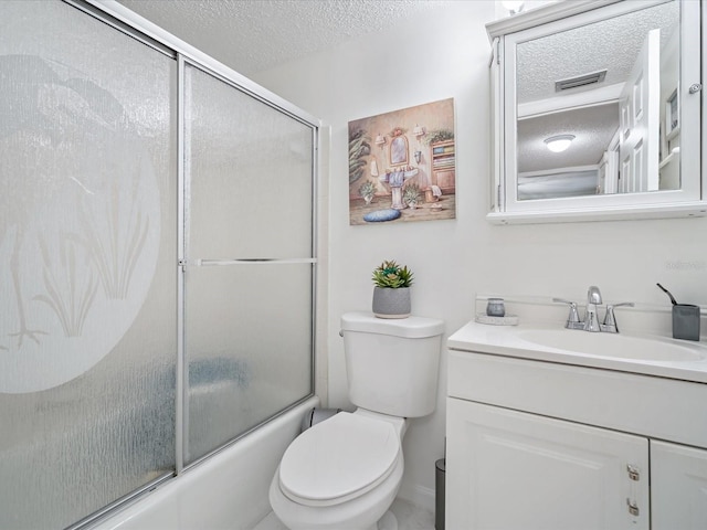 full bathroom with vanity, combined bath / shower with glass door, a textured ceiling, and toilet