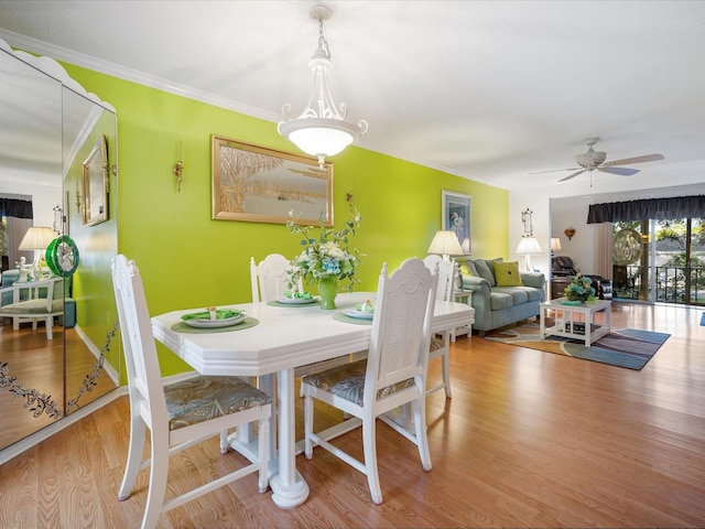 dining area featuring hardwood / wood-style flooring, ceiling fan, and crown molding