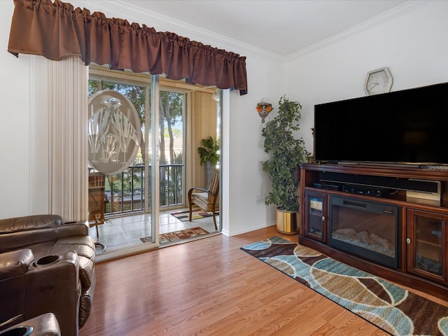 living room featuring wood-type flooring, a wealth of natural light, and crown molding