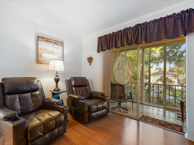 sitting room featuring hardwood / wood-style flooring and crown molding