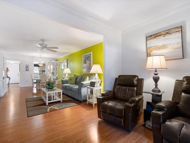 living room featuring ceiling fan, wood-type flooring, and crown molding