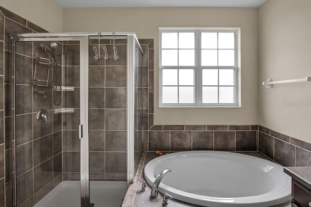 bathroom featuring plus walk in shower and vanity