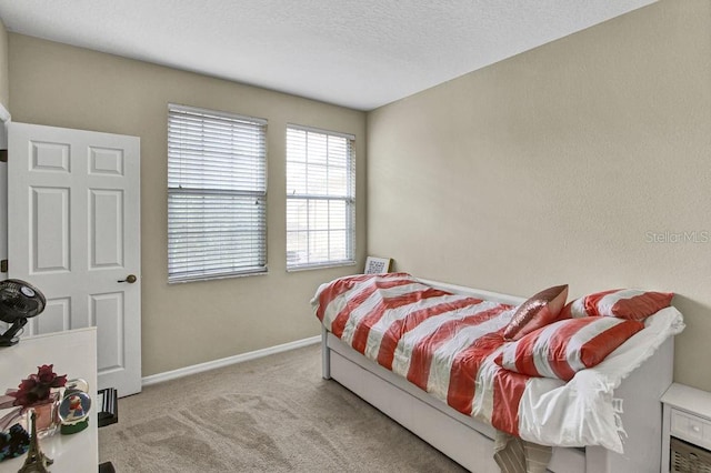 carpeted bedroom featuring a textured ceiling