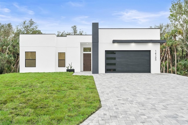 contemporary house with a garage and a front yard