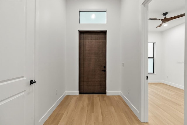 foyer with ceiling fan and light wood-type flooring