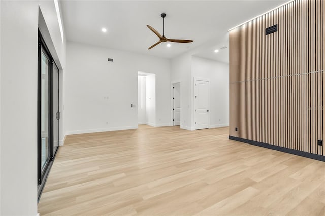 unfurnished living room featuring light wood-type flooring and ceiling fan