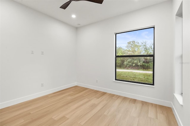 empty room featuring ceiling fan and light hardwood / wood-style flooring