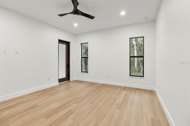 empty room featuring light wood-type flooring and ceiling fan