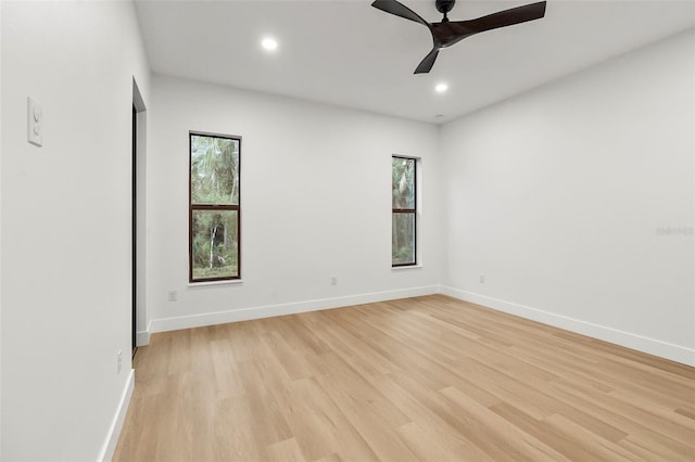 spare room with light hardwood / wood-style flooring, plenty of natural light, and ceiling fan