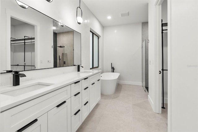 bathroom with tile patterned floors, vanity, and separate shower and tub