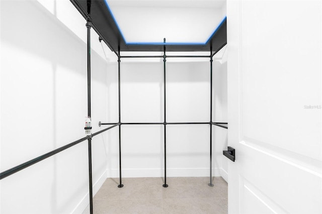 walk in closet featuring light tile patterned flooring