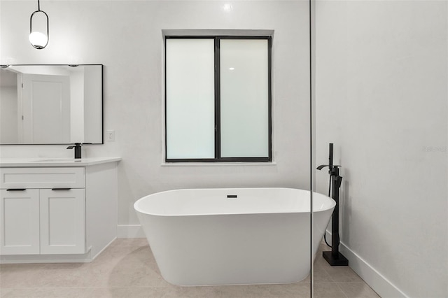 bathroom featuring a tub to relax in, tile patterned floors, and vanity