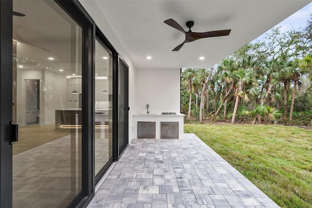 view of patio / terrace featuring ceiling fan