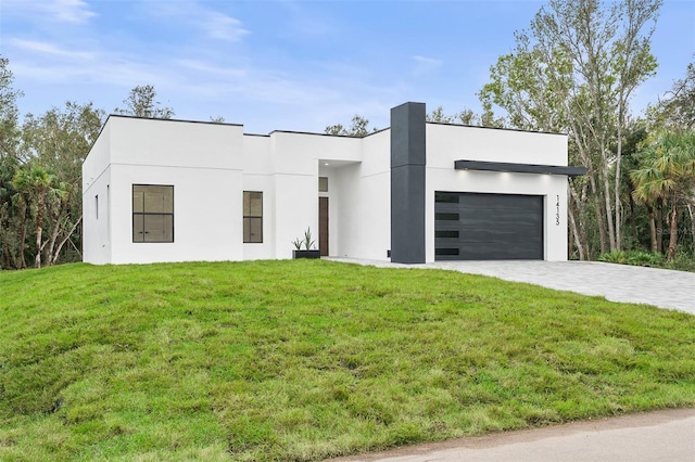 view of front of property with a front lawn and a garage