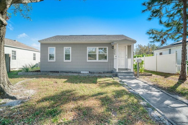 bungalow-style house with a front lawn