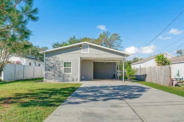 view of front of house with a carport and a front lawn