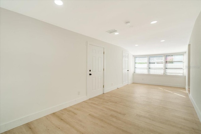 unfurnished room with light hardwood / wood-style floors