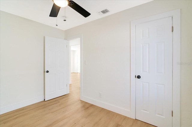 unfurnished bedroom with a closet, ceiling fan, and light hardwood / wood-style flooring