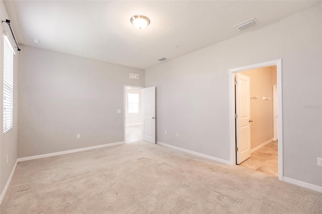 unfurnished bedroom with light colored carpet