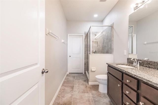 bathroom with vanity, toilet, and walk in shower