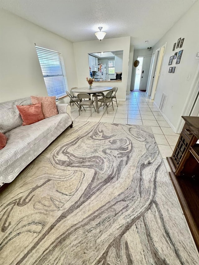 tiled living room with a textured ceiling