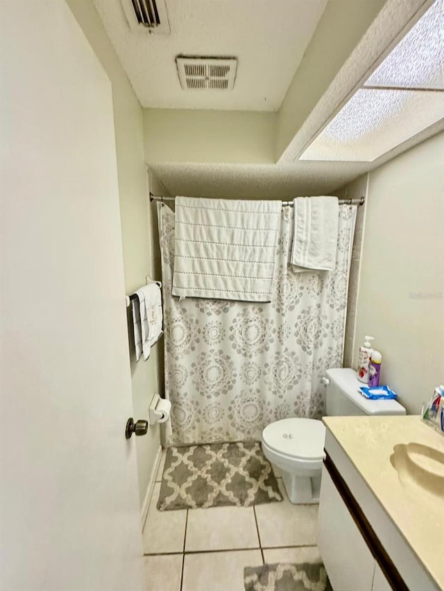 bathroom featuring tile patterned floors, a shower with curtain, vanity, and toilet