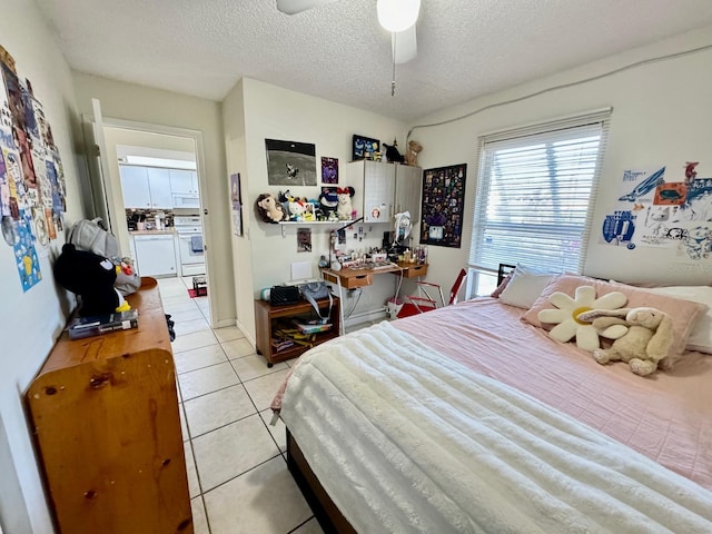 bedroom with ceiling fan, light tile patterned flooring, and a textured ceiling