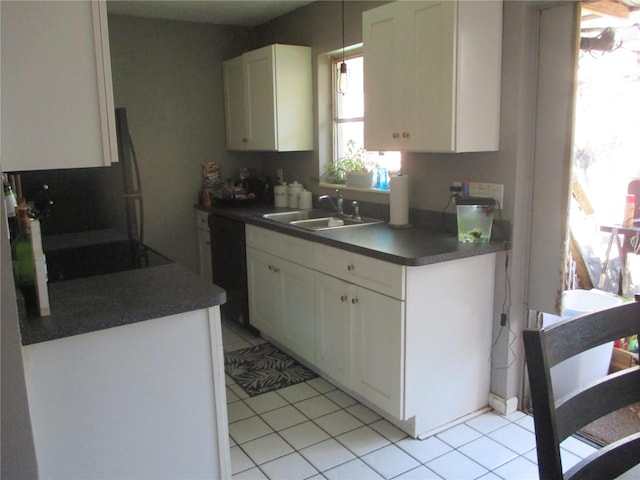 kitchen featuring white cabinets, black dishwasher, light tile patterned flooring, and sink