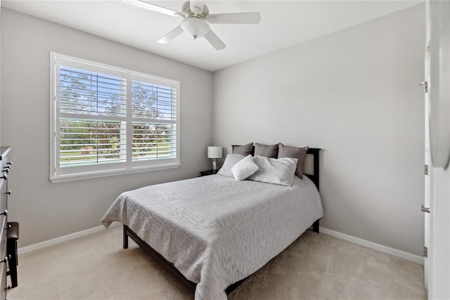 bedroom featuring light carpet and ceiling fan