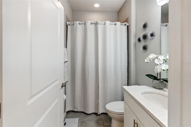 bathroom with tile patterned floors, vanity, and toilet