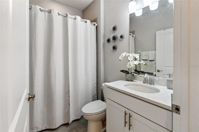 bathroom featuring toilet, vanity, and tile patterned floors