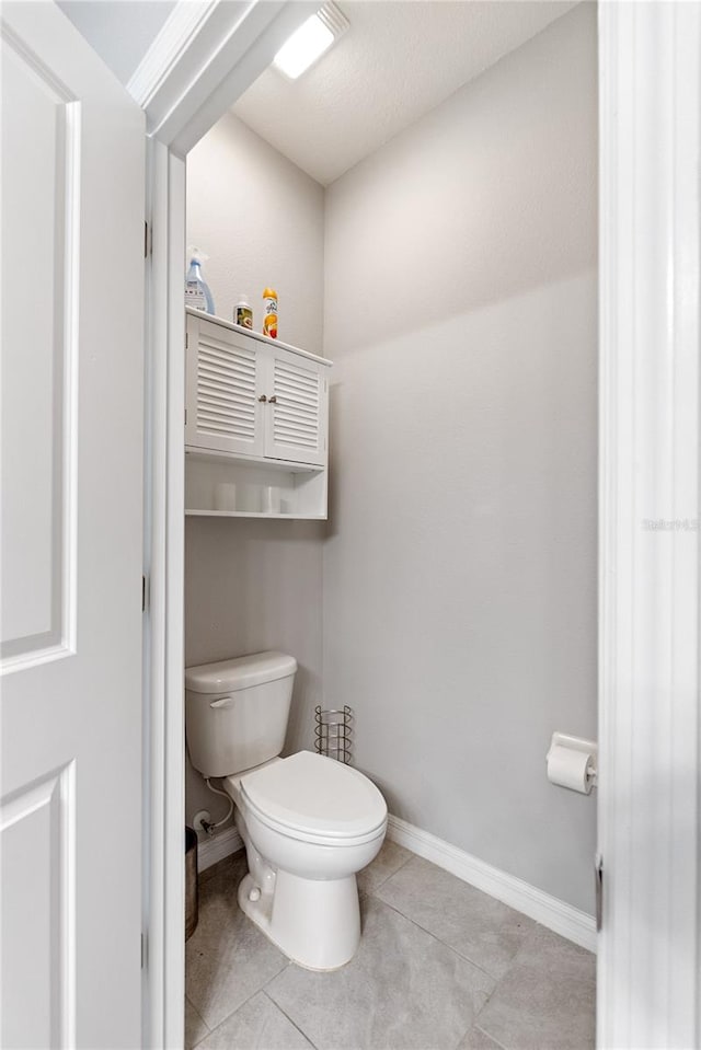 bathroom with tile patterned floors and toilet