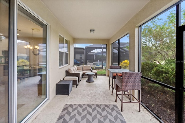 sunroom featuring a chandelier