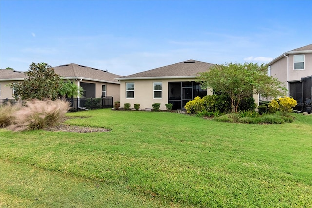 rear view of property with a yard