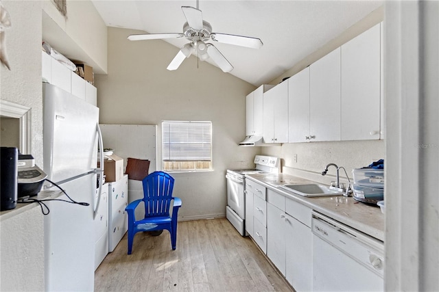 kitchen featuring light wood-type flooring, white appliances, vaulted ceiling, sink, and white cabinets