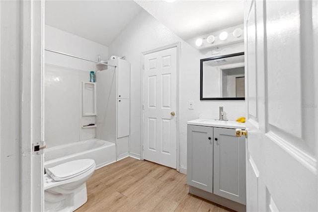 full bathroom featuring vanity, lofted ceiling, toilet, shower / bathtub combination, and wood-type flooring