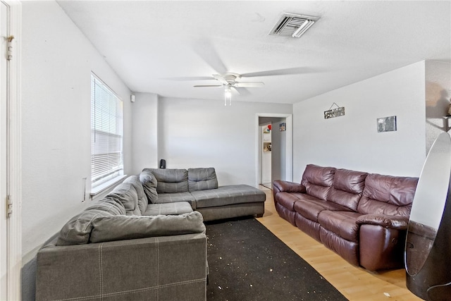 living room with hardwood / wood-style floors and ceiling fan