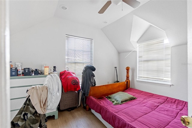 bedroom with hardwood / wood-style flooring, ceiling fan, and lofted ceiling