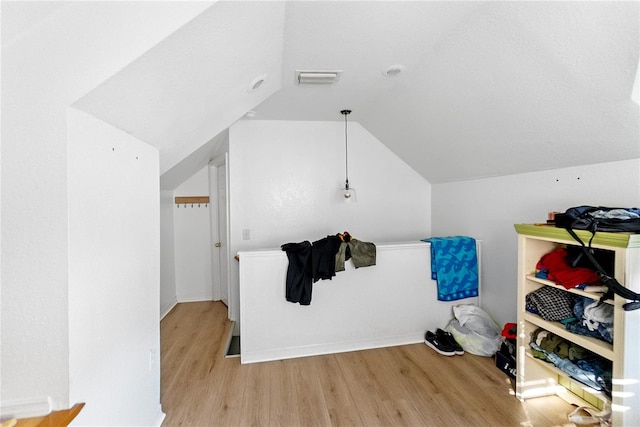 interior space featuring light hardwood / wood-style flooring and lofted ceiling