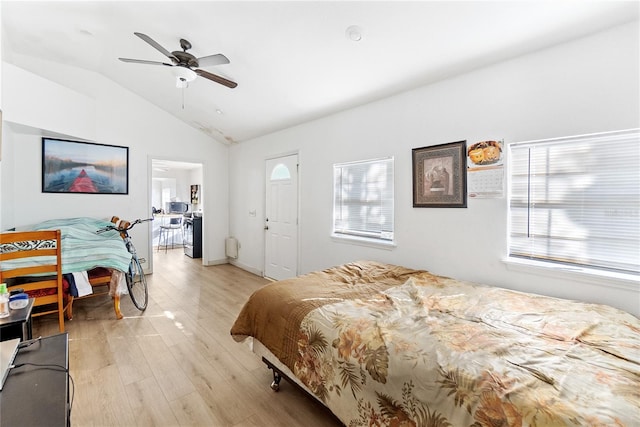 bedroom with multiple windows, ceiling fan, light hardwood / wood-style flooring, and lofted ceiling