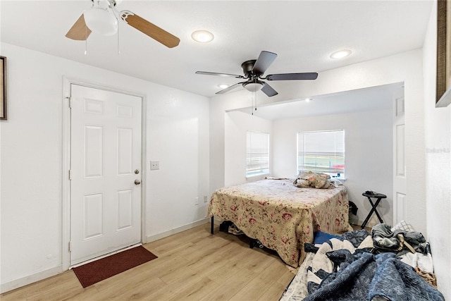 bedroom with ceiling fan and light hardwood / wood-style floors