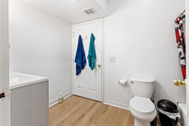1501 14th Ave W, Bradenton, FL 34205 - bathroom with wood finished floors, baseboards, toilet, and vanity