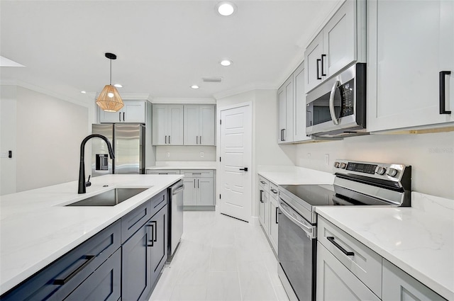 kitchen featuring light stone countertops, stainless steel appliances, sink, gray cabinets, and hanging light fixtures