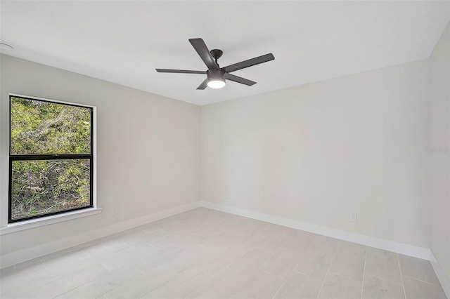 unfurnished room featuring ceiling fan and a wealth of natural light