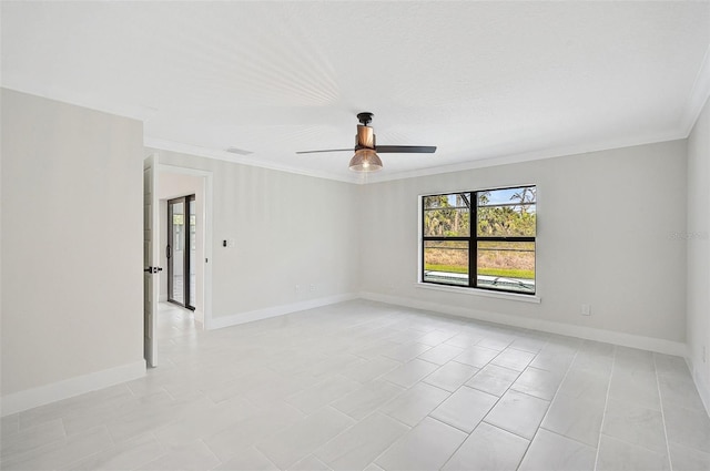 spare room with ceiling fan, ornamental molding, and light tile patterned flooring