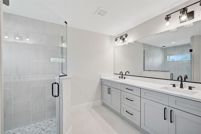 bathroom featuring vanity and an enclosed shower