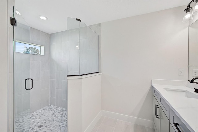 bathroom featuring tile patterned flooring, vanity, and a shower with shower door